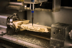 Showing the 4-axis CNC machine carving a kréddle custom violin chin rest in flamed maple.