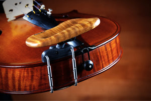 Close-up of kréddle custom chin rest on a viola in gold color.